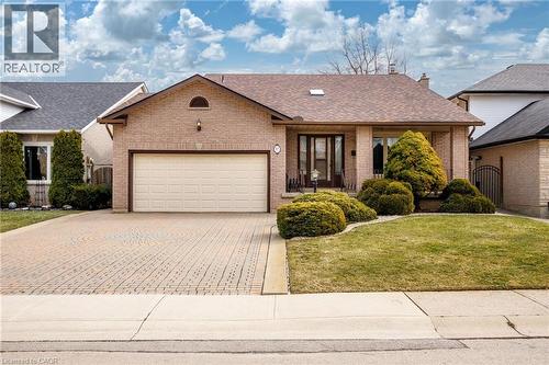 Single story home featuring brick siding, a garage, decorative driveway, and roof with shingles - 57 Derek Drive, Hamilton, ON - Outdoor
