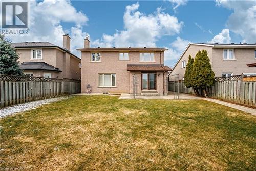 Back of house with a patio area, brick siding, a fenced backyard, and a chimney - 57 Derek Drive, Hamilton, ON - Outdoor