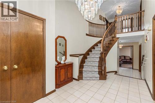 Stairs featuring hanging lights, a high ceiling, and tile patterned floors - 57 Derek Drive, Hamilton, ON - Indoor Photo Showing Other Room