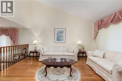 Living area featuring lofted ceiling and wood finished floors - 57 Derek Drive, Hamilton, ON - Indoor Photo Showing Living Room