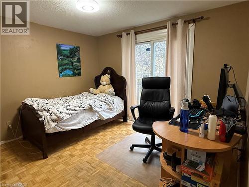 Bedroom featuring parquet flooring and a textured ceiling - 60 Helene Crescent, Waterloo, ON - Indoor Photo Showing Bedroom