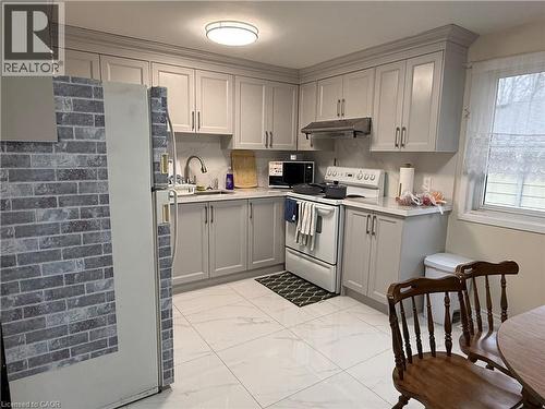 Kitchen featuring gray cabinets, white electric range, light countertops, and freestanding refrigerator - 60 Helene Crescent, Waterloo, ON - Indoor Photo Showing Kitchen