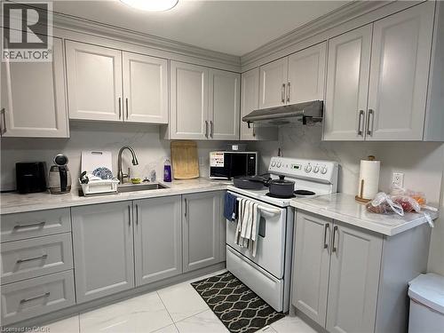 Kitchen featuring white electric range, gray cabinets, light marble finish flooring, and light stone counters - 60 Helene Crescent, Waterloo, ON - Indoor Photo Showing Kitchen
