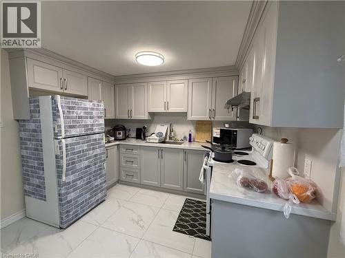 Kitchen featuring gray cabinetry, freestanding refrigerator, light marble finish flooring, electric range, and black microwave - 60 Helene Crescent, Waterloo, ON - Indoor Photo Showing Kitchen