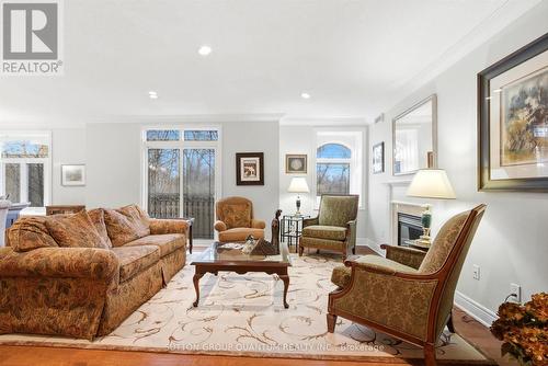 305 - 390 Upper Middle Road E, Oakville, ON - Indoor Photo Showing Living Room With Fireplace
