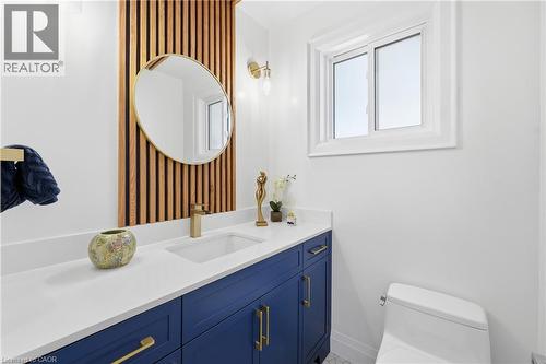 Half bath with vanity and wallpapered walls - 273 Bryant Crescent, Burlington, ON - Indoor Photo Showing Bathroom