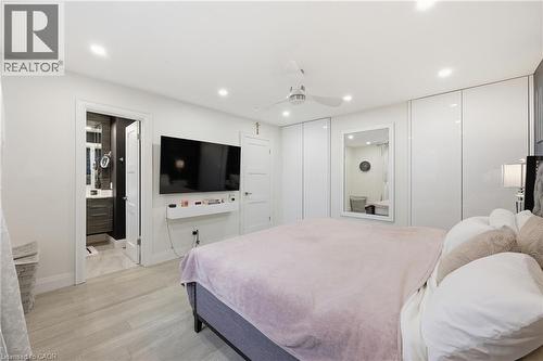 Bedroom with light wood-style floors, multiple closets, recessed lighting, a ceiling fan, and ensuite bathroom - 273 Bryant Crescent, Burlington, ON - Indoor Photo Showing Bedroom
