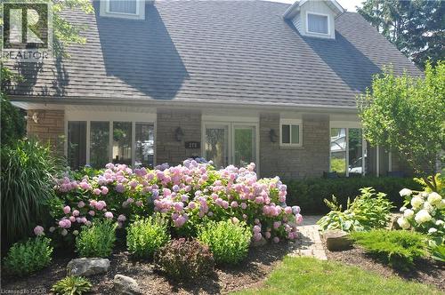 Rear view of house featuring roof with shingles and stone siding - 273 Bryant Crescent, Burlington, ON - Outdoor