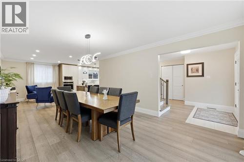 Dining area featuring ornamental molding, light wood finished floors, and a chandelier - 273 Bryant Crescent, Burlington, ON - Indoor Photo Showing Dining Room