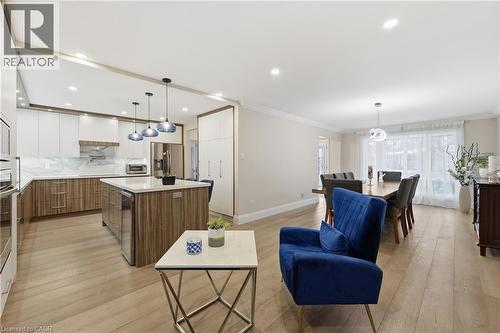 Living area with crown molding, light wood-style floors, wine cooler, and recessed lighting - 273 Bryant Crescent, Burlington, ON - Indoor