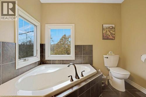 Bathroom featuring a garden tub and dark tile patterned flooring - 5511 Second Line, Erin, ON - Indoor Photo Showing Bathroom