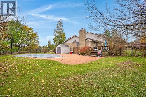 Rear view of property featuring a fenced backyard, a storage shed, a chimney, and a patio - 5511 Second Line, Erin, ON - Outdoor