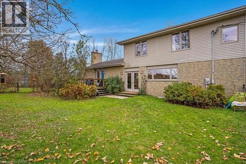 Rear view of property featuring brick siding, a lawn, a chimney, and french doors - 5511 Second Line, Erin, ON - Outdoor