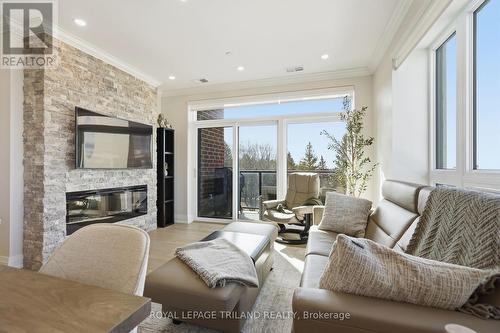 310 - 1560 Upper West Avenue, London South (South B), ON - Indoor Photo Showing Living Room With Fireplace