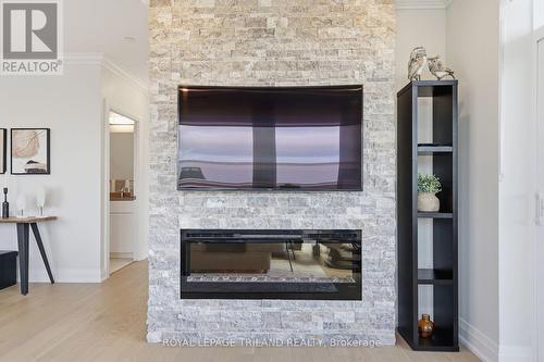 310 - 1560 Upper West Avenue, London South (South B), ON - Indoor Photo Showing Living Room With Fireplace