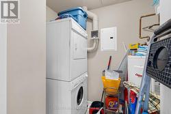 Utility closet off kitchen w stacked GE - W+D. - 