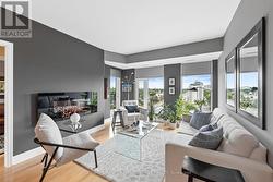 Living room w floor to ceiling windows. - 