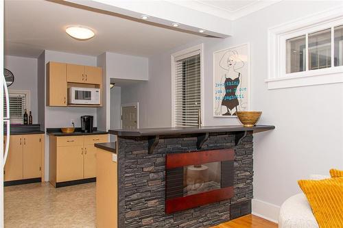 Living Room towards Kitchen (note electric fireplace) - 701 Sherburn Street, Winnipeg, MB - Indoor Photo Showing Kitchen