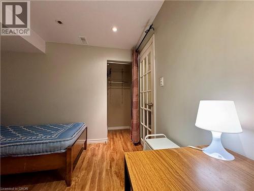 Bedroom featuring light wood-style flooring, recessed lighting, a spacious closet, and an office area - 86 Devonglen Drive, Kitchener, ON - Indoor Photo Showing Bedroom