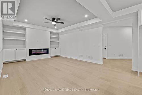 Family room w/BI cabinets, f/p, tray ceiling. - 4705 Lee Avenue, Niagara Falls (Ascot), ON - Indoor Photo Showing Other Room With Fireplace