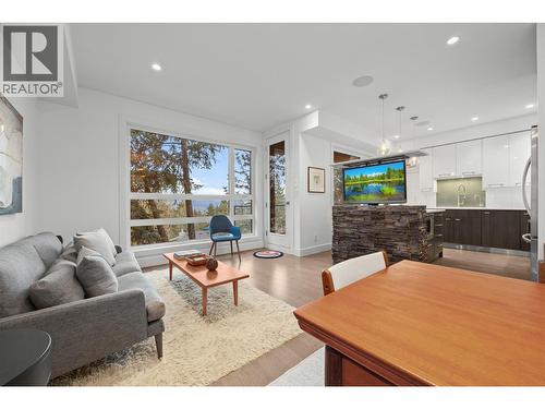 Living room with TV exposed via TV lift - 1818 Peak Point Court Unit# 3, West Kelowna, BC - Indoor Photo Showing Living Room