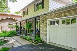 Welcoming front porch surrounded by landscaping. - 