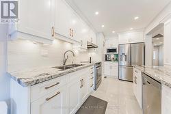 Under valence lighting, pullout garbage on left - 