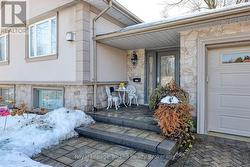 Interlocking walkways lead to a covered porch. - 