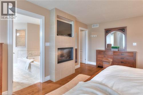 363 Golf Course Road, Conestogo, ON - Indoor Photo Showing Bedroom With Fireplace