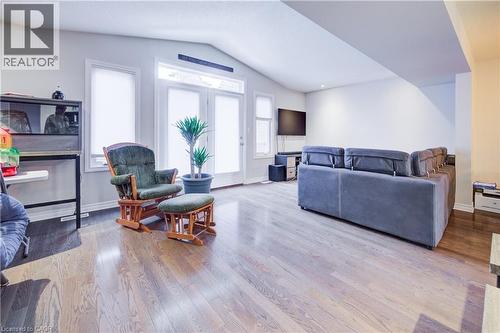 Living area featuring vaulted ceiling and wood finished floors - 34 Harrison Street, Stratford, ON - Indoor Photo Showing Living Room
