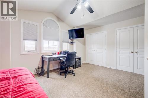 Bedroom with two closets, light carpet, vaulted ceiling, an office area, and ceiling fan - 34 Harrison Street, Stratford, ON - Indoor
