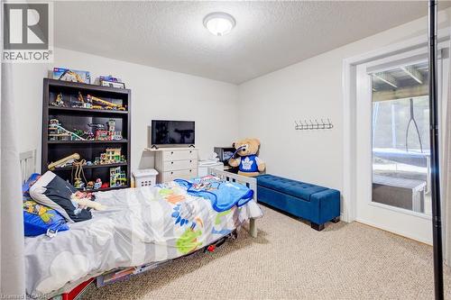Carpeted bedroom featuring a textured ceiling - 34 Harrison Street, Stratford, ON - Indoor Photo Showing Bedroom