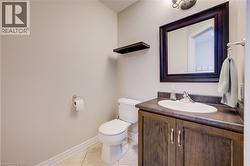 Bathroom with vanity and light tile patterned floors - 