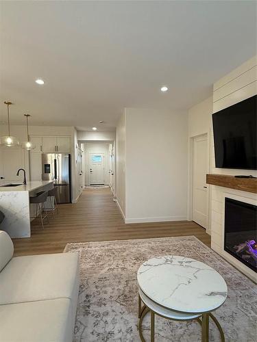 74 Outback Drive, Brandon, MB - Indoor Photo Showing Living Room With Fireplace