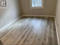Spare room featuring light wood-type flooring - 