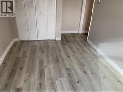 Unfurnished bedroom featuring light wood-style floors and a closet - 