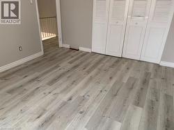 Unfurnished bedroom with light wood finished floors and a closet - 