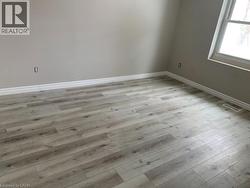 Spare room with baseboards and light wood finished floors - 