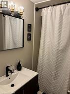 Full bathroom with a shower with shower curtain and vanity - 