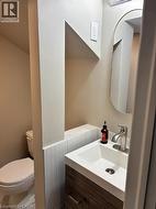 Half bath with vanity and toilet - 