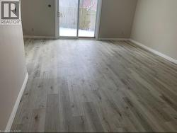 Spare room featuring baseboards and light wood-style flooring - 
