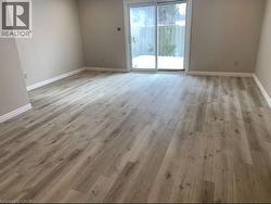 Spare room featuring baseboards and light wood-style flooring - 