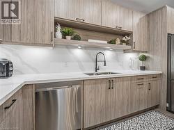 Kitchen featuring open shelves, stainless steel appliances, and modern cabinets - 
