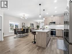 Kitchen with open floor plan, stainless steel appliances, modern cabinets, and a kitchen bar - 