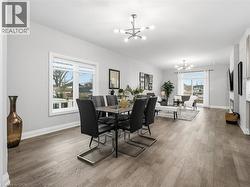 Dining area with hanging lights and light wood-style flooring - 