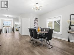 Dining space featuring hanging lights and wood finished floors - 