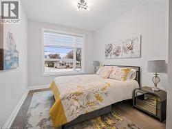 Bedroom with wood finished floors and baseboards - 