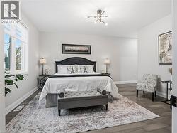 Bedroom with baseboards and dark wood-type flooring - 