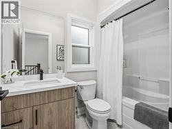 Bathroom with vanity and shower / tub combo with curtain - 