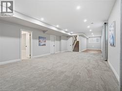 Basement with light carpet and recessed lighting - 